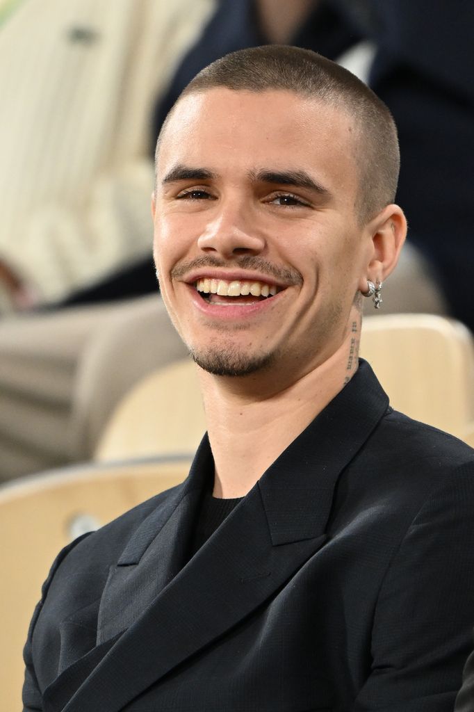 Romeo Beckham with a massive grin
