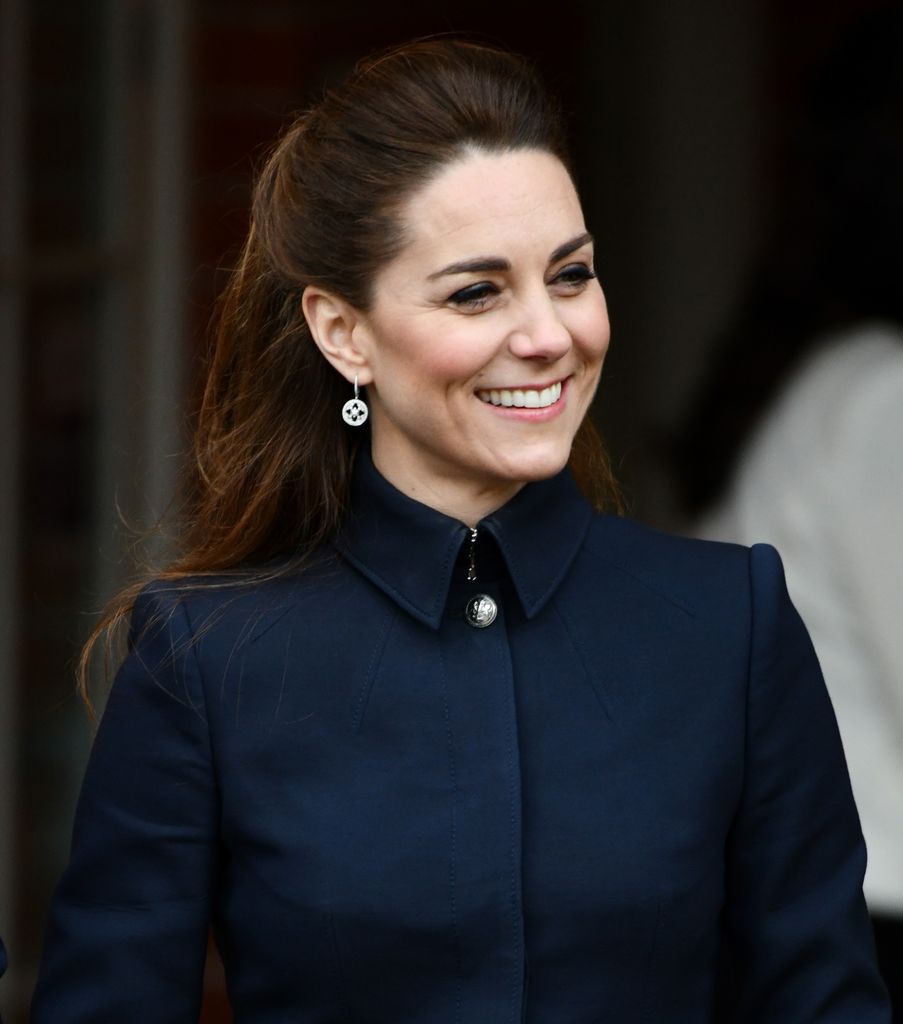 Kate  smiling in navy structured coat