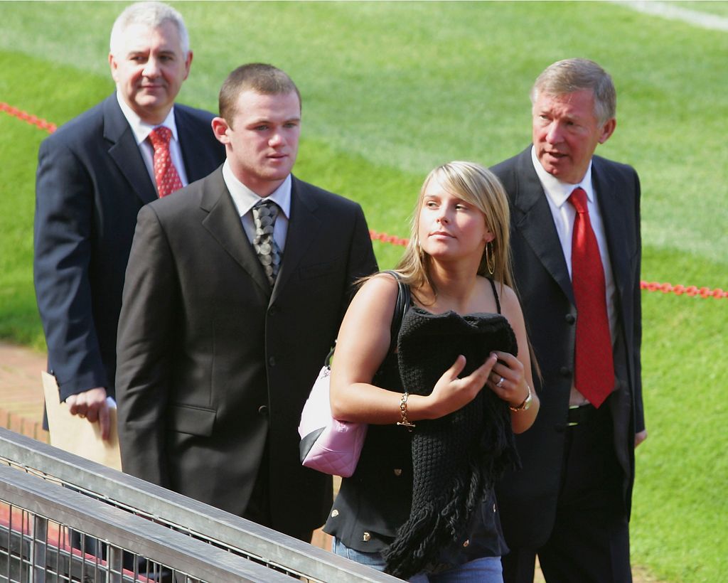 Manager Sir Alex Ferguson, Wayne Rooney of Mancester United with fiancee Coleen McLoughlin and Agent Paul Stretford on pitch