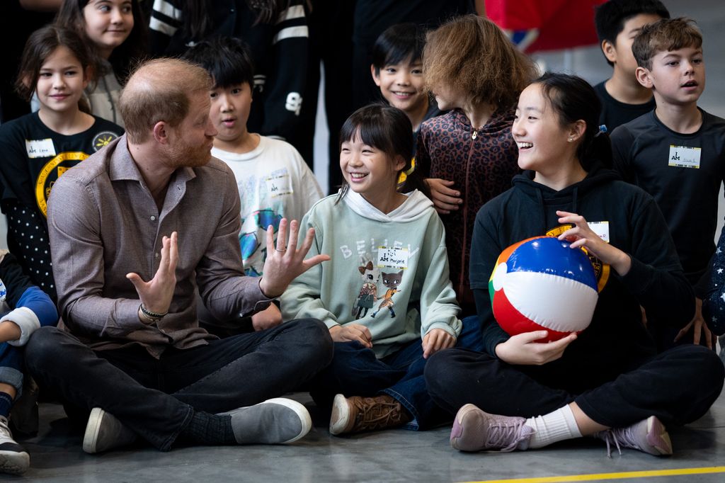 Prince Harry, the Duke of Sussex, speaks with elementary school students during the Invictus Games 2025 School Programme