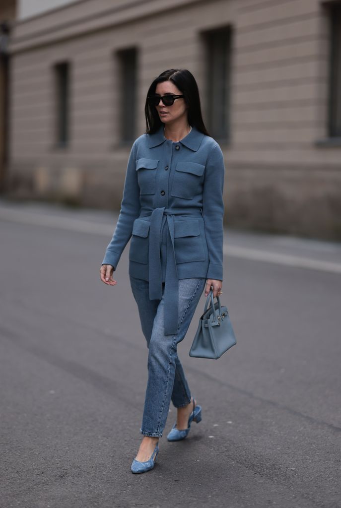 Leo Eberlin seen wearing Bottega Veneta black sunglasses, Leo Mathild diamond jewelry / diamond rings, Allude x Leo Mathild blue cashmere wool cardigan jacket, Zara blue denim straight leg jeans / pants, HermÃ¨s Birkin blue leather bag and Chanel denim fabric logo pattern heels, on February 25, 2024 in Berlin, Germany. (Photo by Jeremy Moeller/Getty Images)