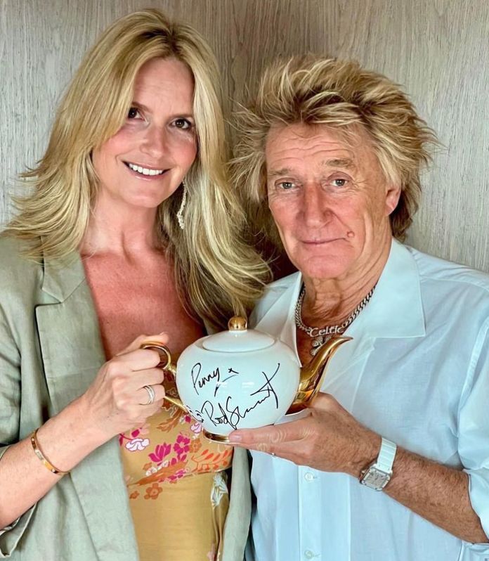 Penny Lancaster and Rod Stewart holding a signed teapot