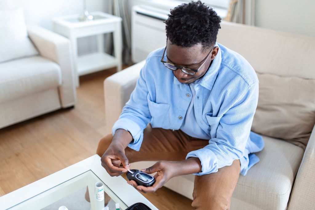 young man with diabetes glucose monitor.