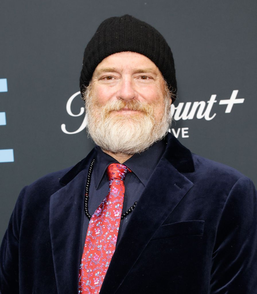 john carter cash wearing a beanie and tie