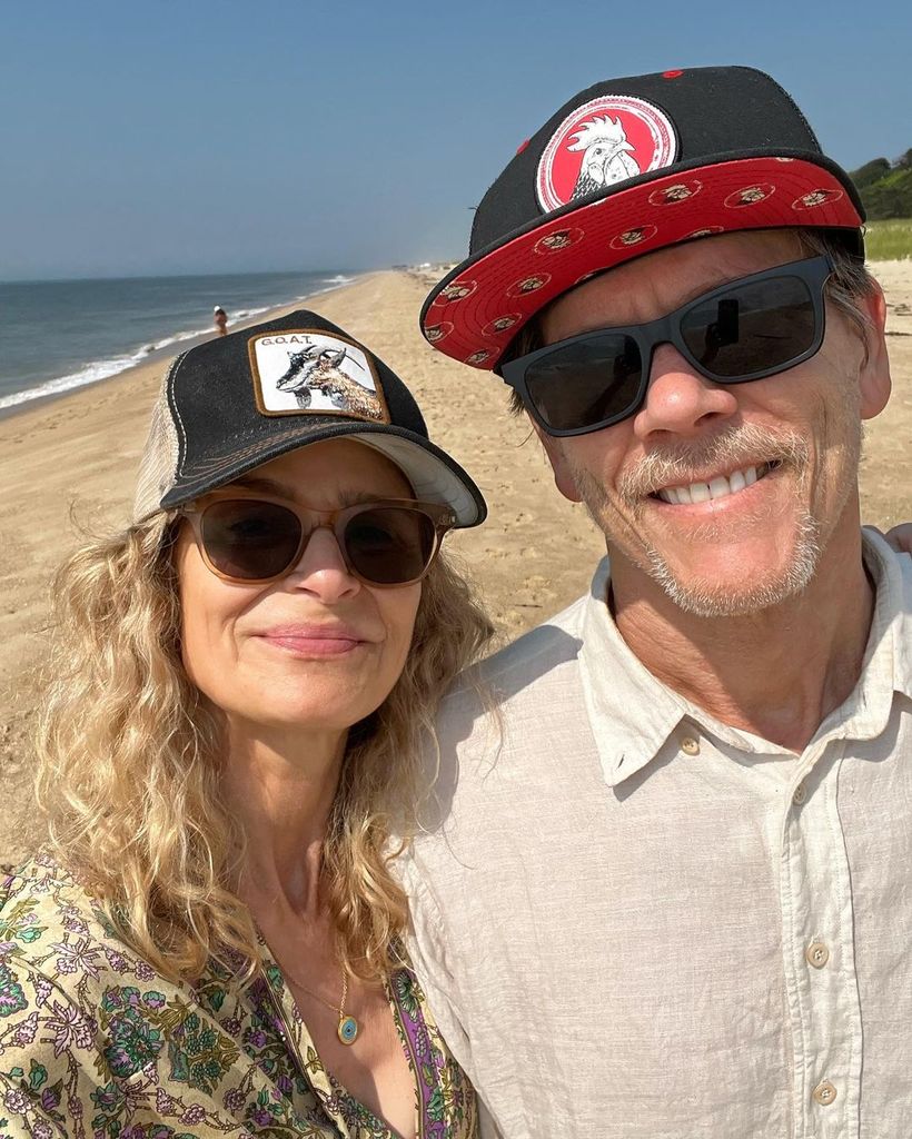 Kyra and Kevin smiling at the beach both wearing sunglasses