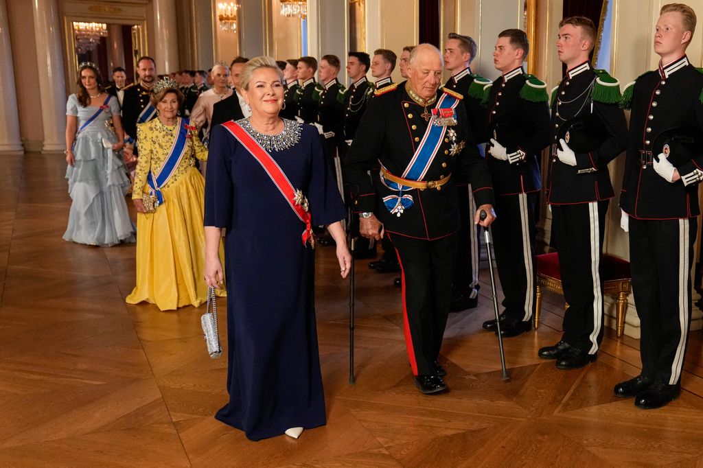 Norway's King Harald (R) walks next to Iceland's President Halla Tomasdottir at the gala dinner