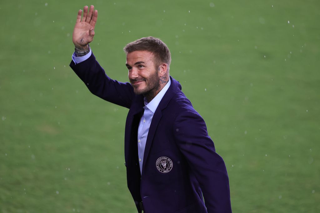 David Beckham waving while on a football pitch