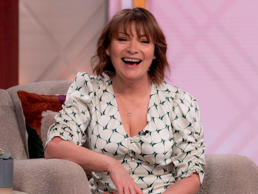 Lorraine Kelly laughing in a white dress