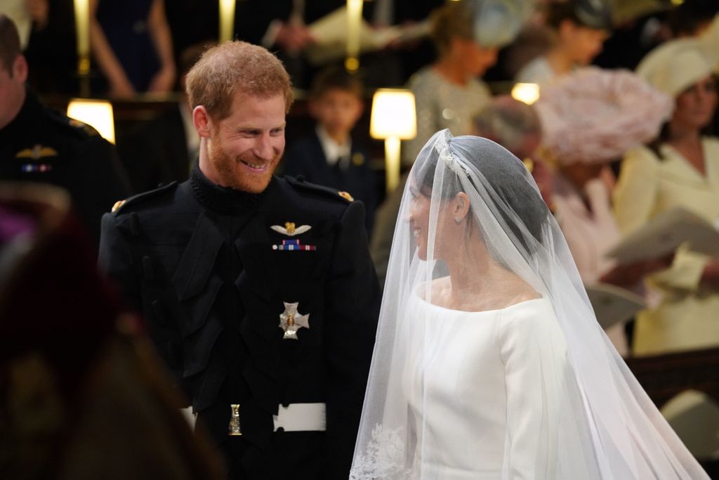 Harry and Meghan smiling at each other at the altar