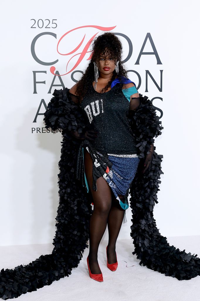 Precious Lee attends the 2025 CFDA Awards wearing a sporty inspired dress and long black feather boa