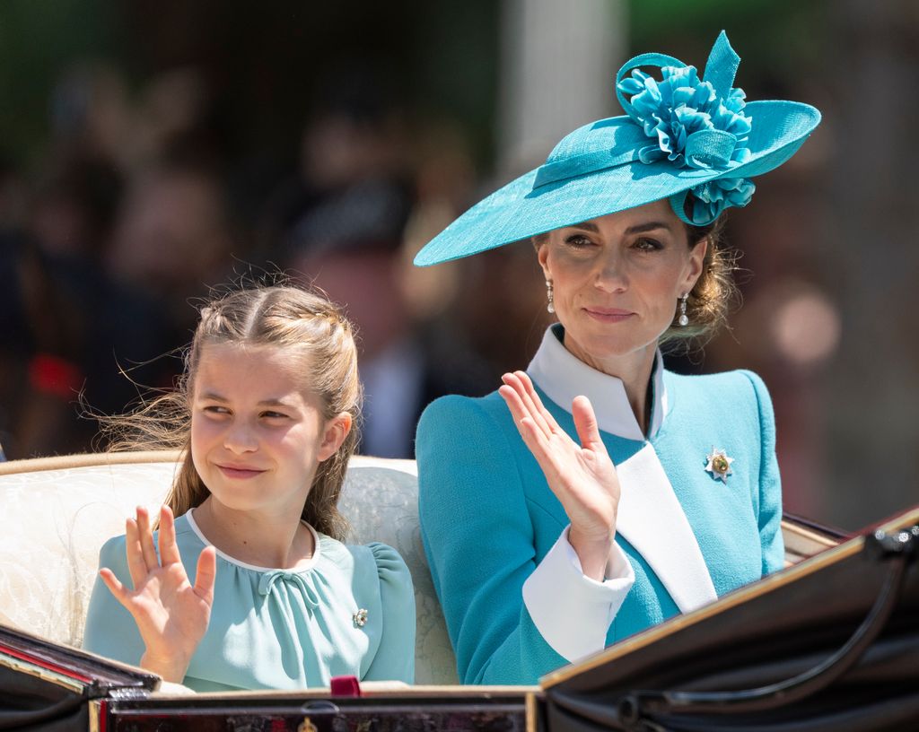 Princess Charlotte waving in a blue dress