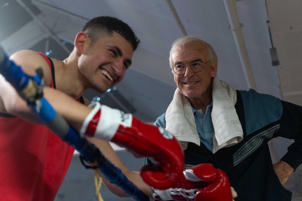 boxer in ring next to coach