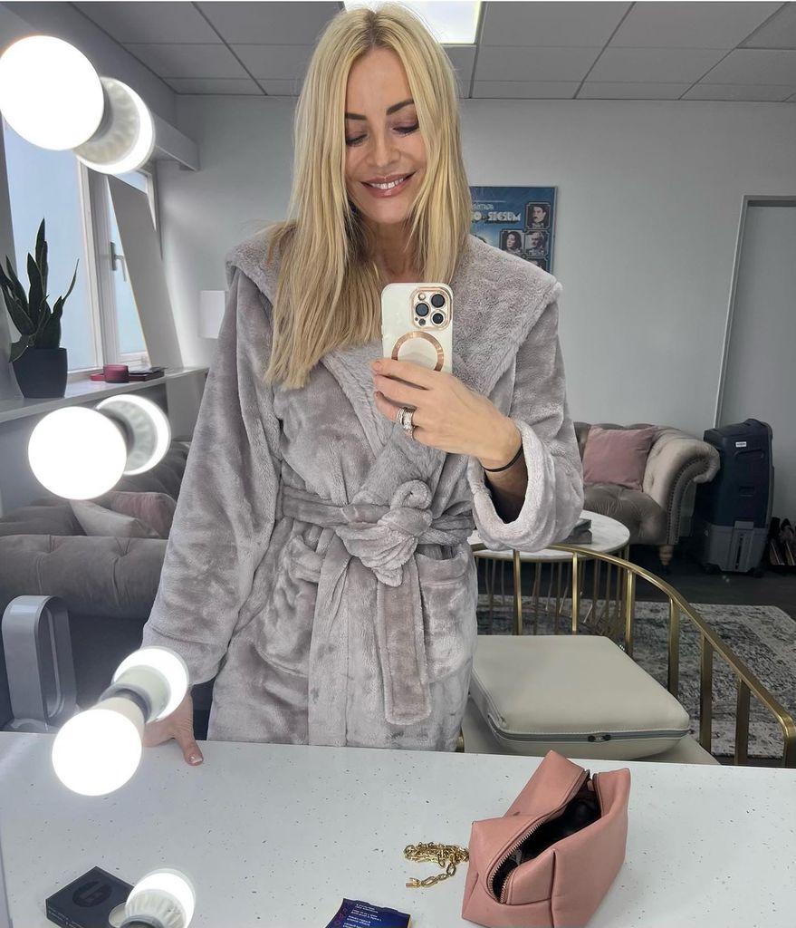 Tess Daly wearing a dress gown in her dressing room