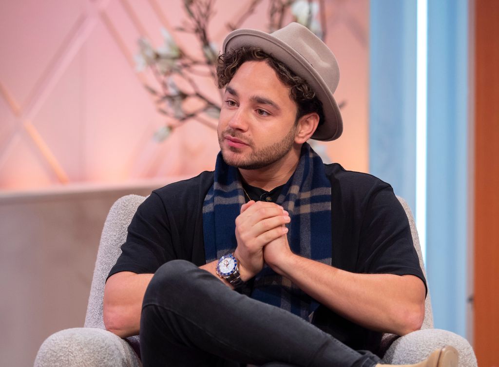 Adam Thomas in hat and scarf