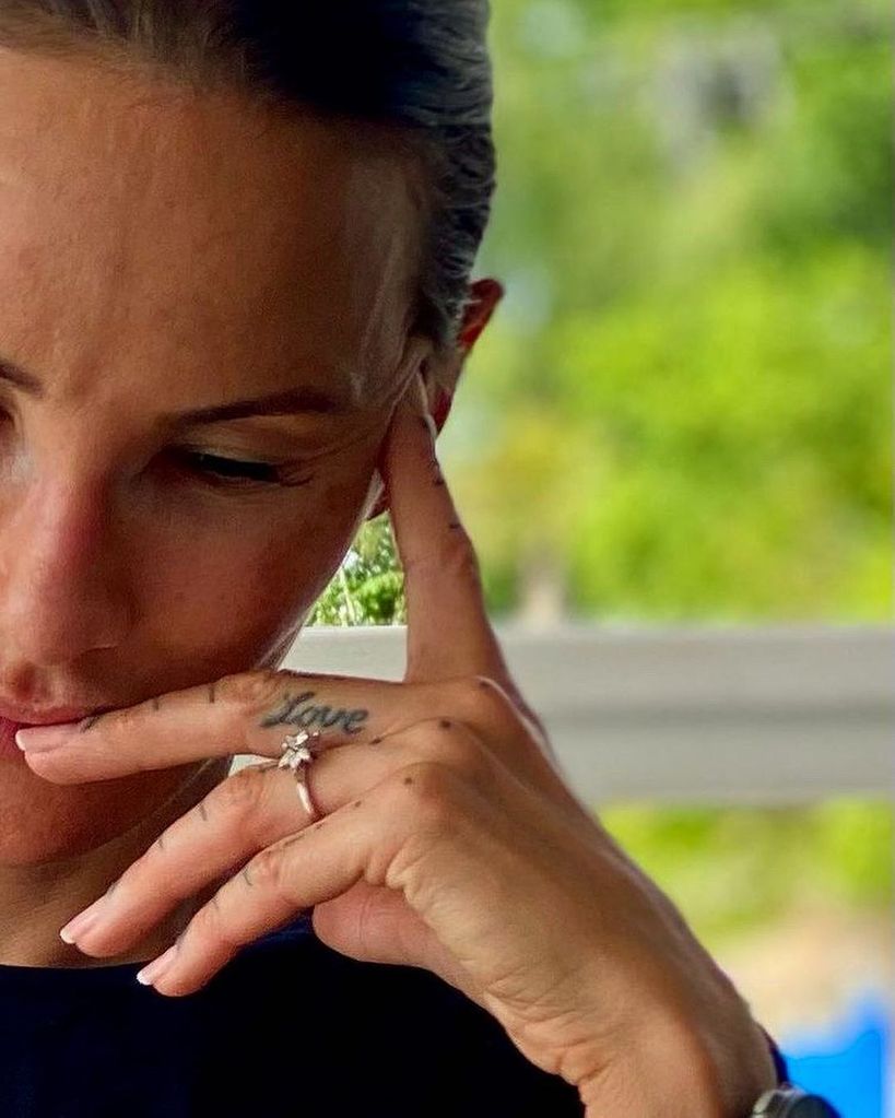 Lisa Zbozen wearing her diamond engagement ring with her hand to her face