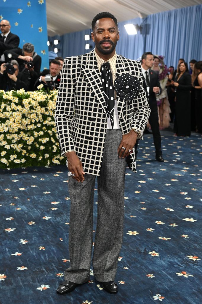 Colman Domingo wears a black and white checked blazer, polka dot tie and grey checked trousers