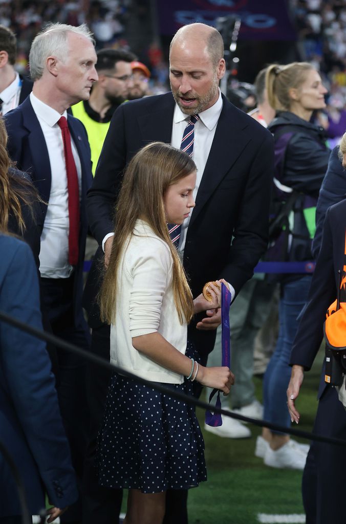 Prince William handed over one of the medals to Princess Charlotte