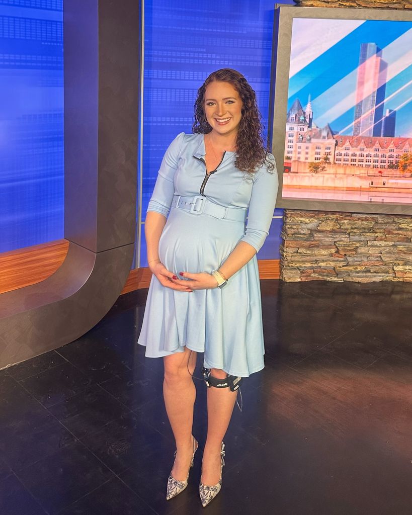 Olivia Jacquith cradling her bump