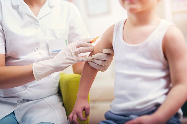 doctor vaccinating child
