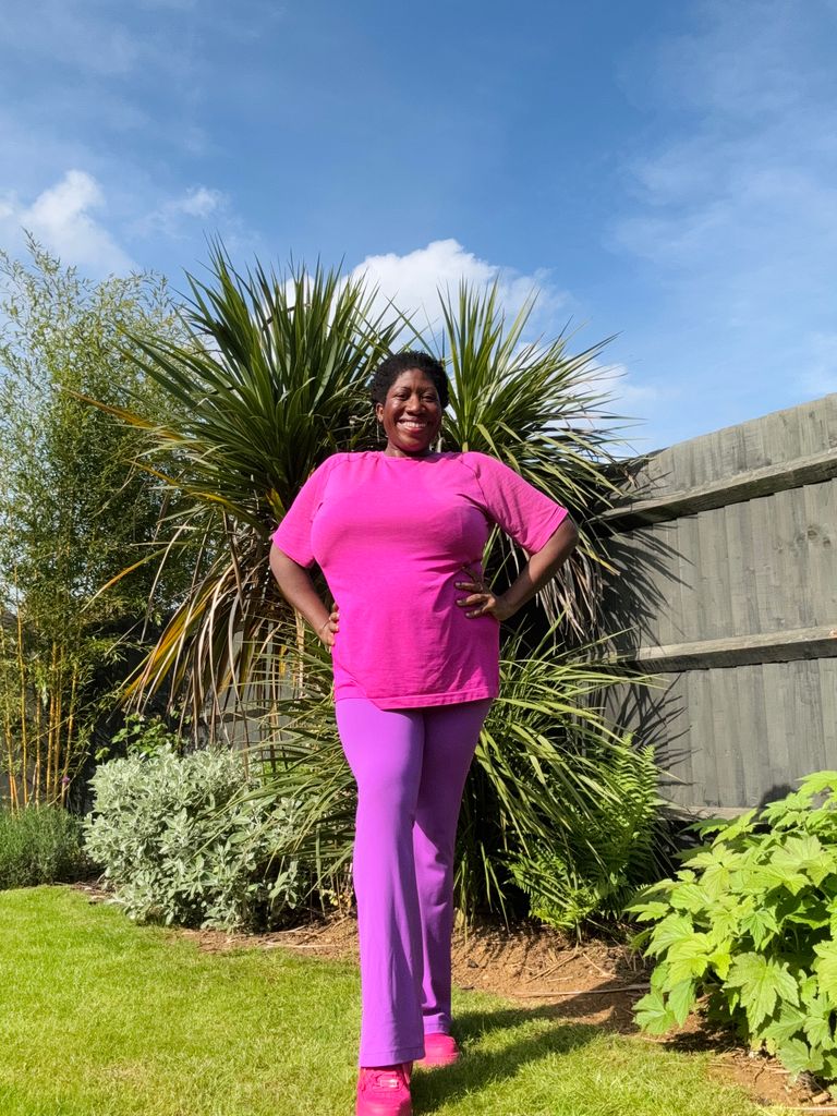 woman in pink clothes posing in the garden