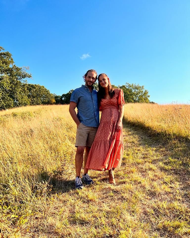 Michael Rady and his wife Rachael stand in a farm field
