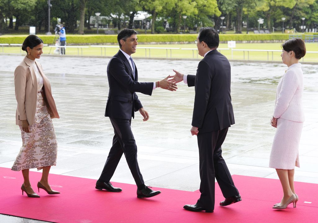HIROSHIMA, JAPAN - MAY 19: British Prime Minister Rishi Sunak (2L) and his wife Akshata Murty (L) are welcomed by Japanese Prime Minister Fumio Kishida (2R) and First Lady Yuko Kishida during a visit to the Peace Memorial Park on the sidelines of the G7 summit on May 19, 2023 in Hiroshima, Japan. The G7 summit will be held in Hiroshima from 19-22 May. (Photo by Franck Robichon - Pool/Getty Images)