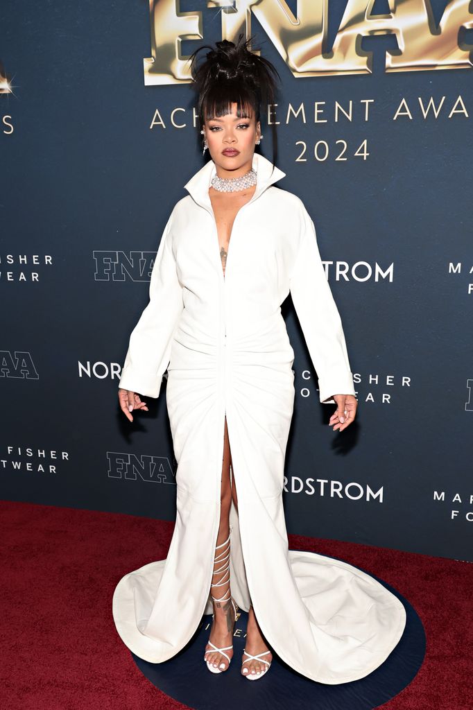 Rihanna on red carpet in white dress 