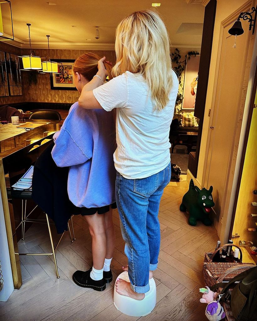 Georgia Tennant doing daughter's hair at home