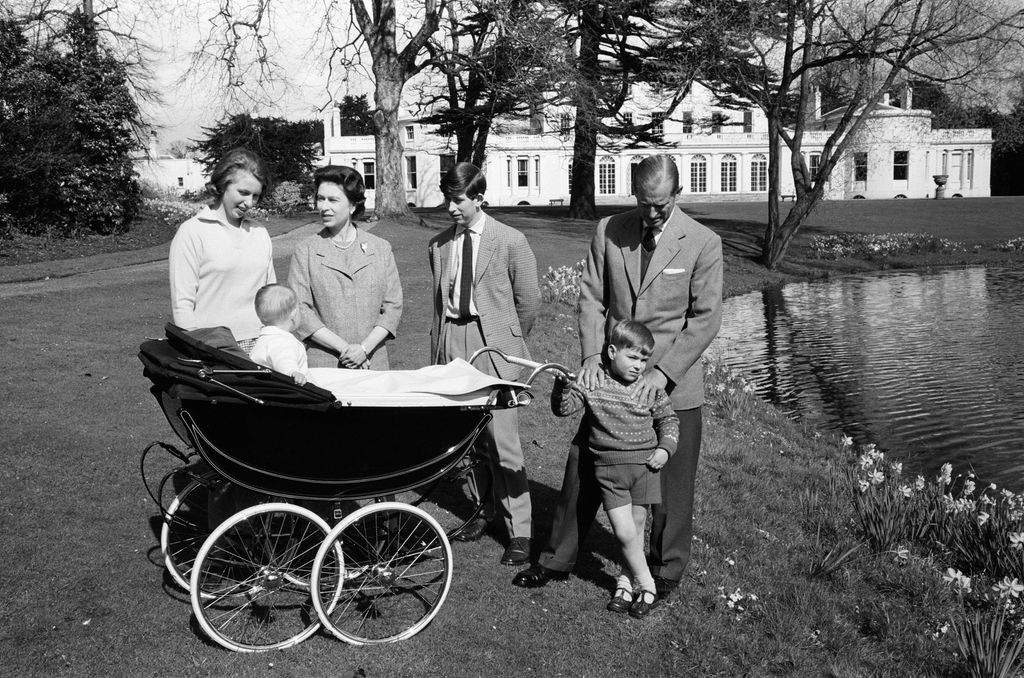 family around a pram beside a pond