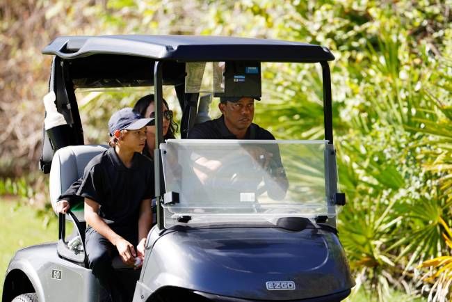 Tiger Woods with his son Charlie and girlfriend Erica Herman