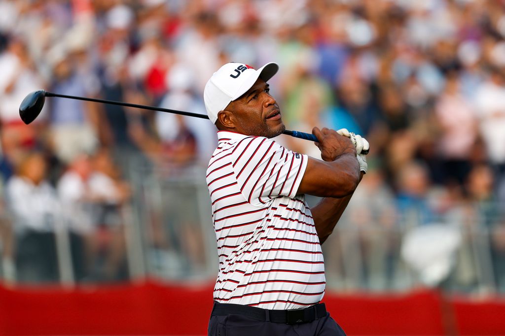 Michael Strahan plays his shot from the first tee prior to the Ryder Cup 2025 at Black Course at Bethpage State Park Golf Course on September 24, 2025 in Farmingdale, New York.