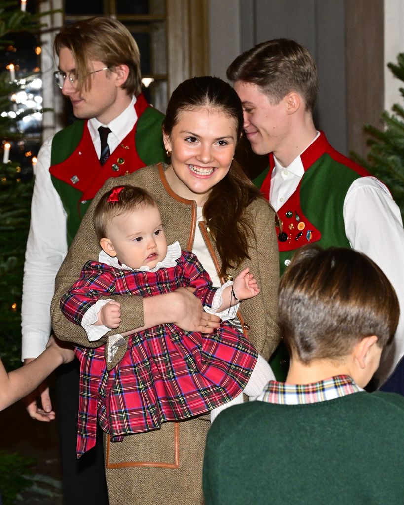 Princess Ines held by Princess Estelle grinning