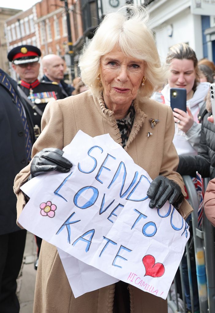 Queen Camilla holds sign 'Send Our Love to Kate'