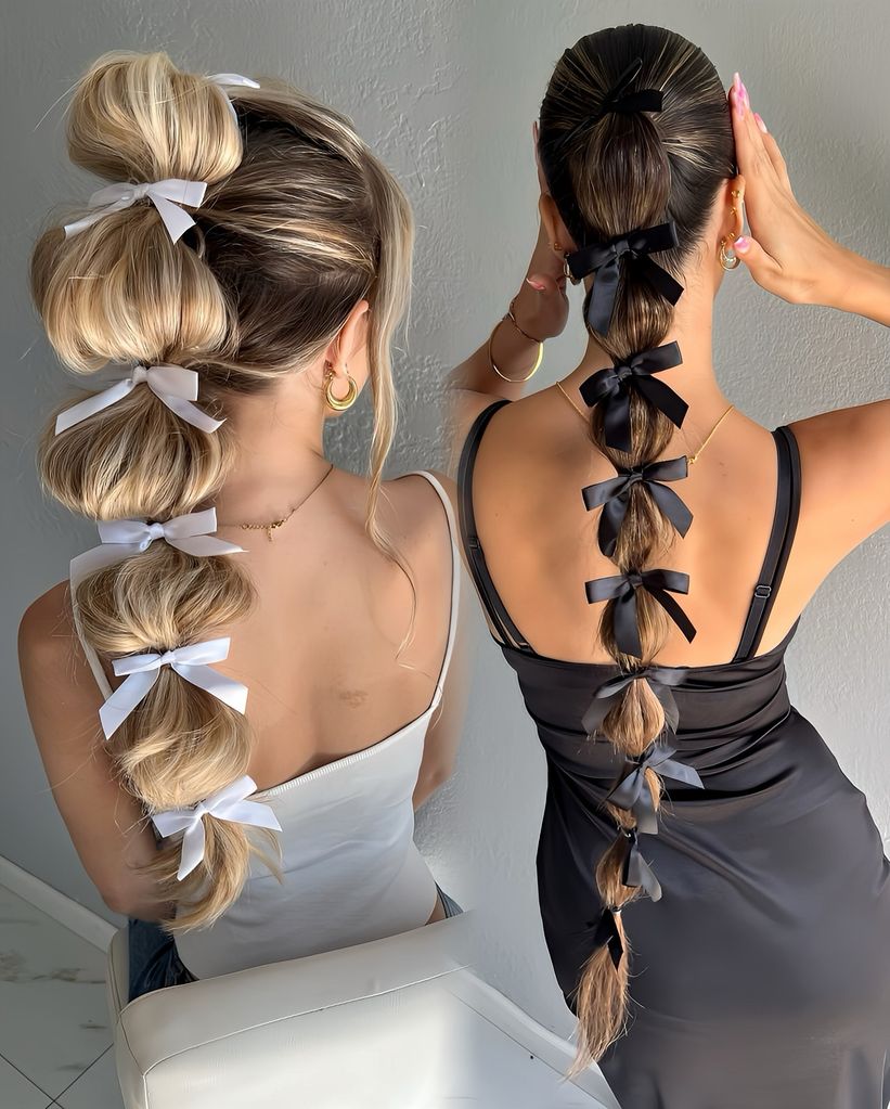 Two girls pose with braids adorned with tiny bows