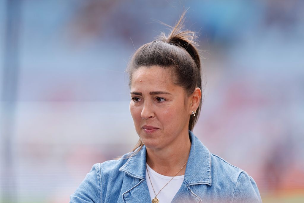 Fara Williams looking serious in a blue denim jacket