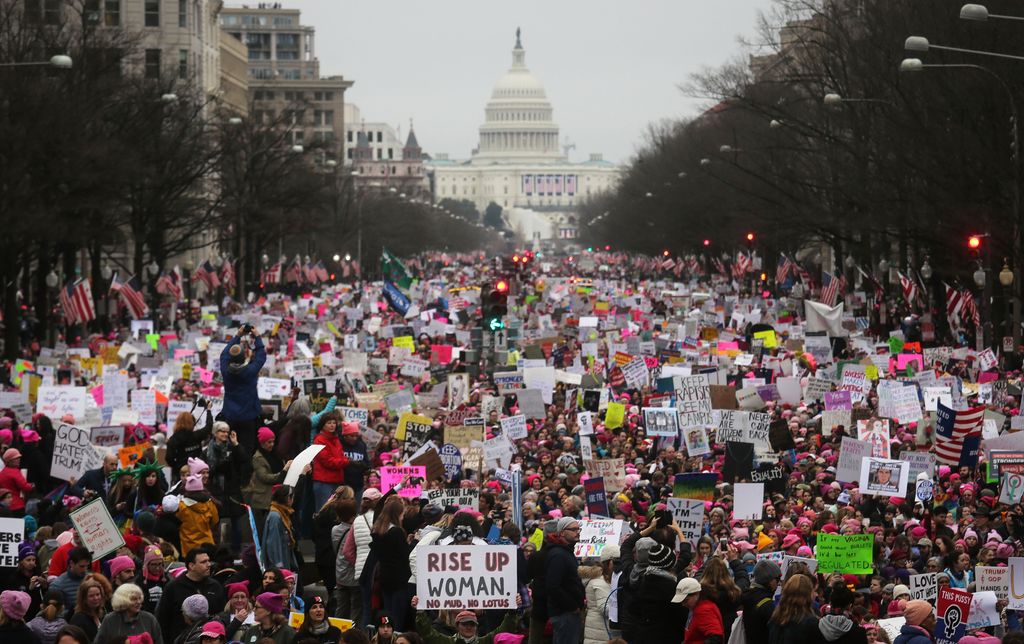 Protesters walk during the Women's March on Washington, with the U.S. Capitol in the background, on January 21, 2017 in Washington, DC. Large crowds are attending the anti-Trump rally a day after U.S. President Donald Trump was sworn in as the 45th U.S. president.