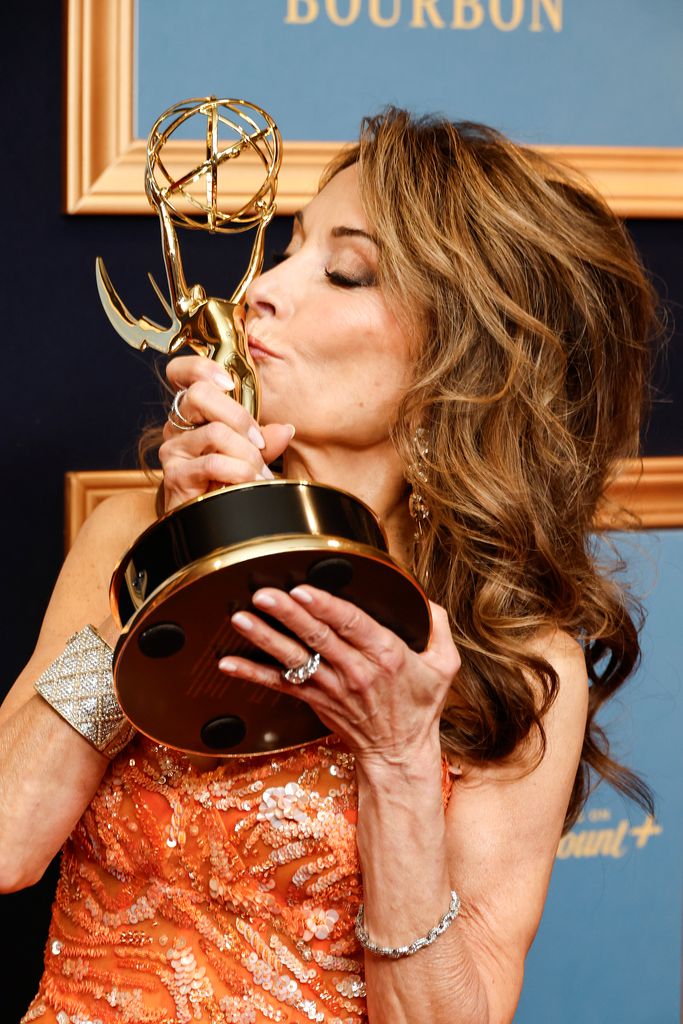Susan Lucci kisses with her Lifetime Achievement Award during the 50th Daytime Emmy Awards 