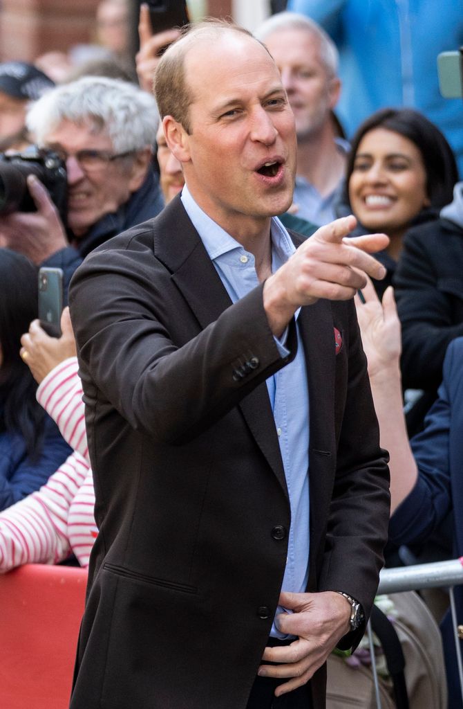 Prince William pointing and laughing