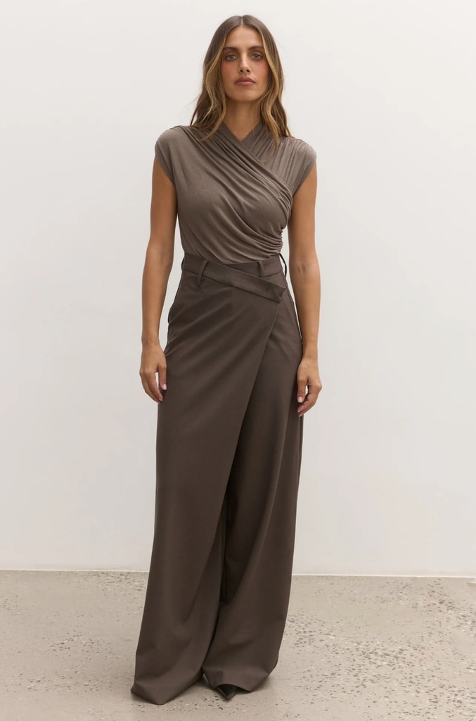 A model poses in grey trousers