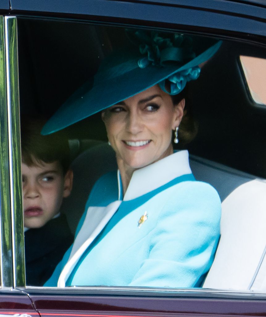 Kate Middleton in blue coat and hat and pearl earrings