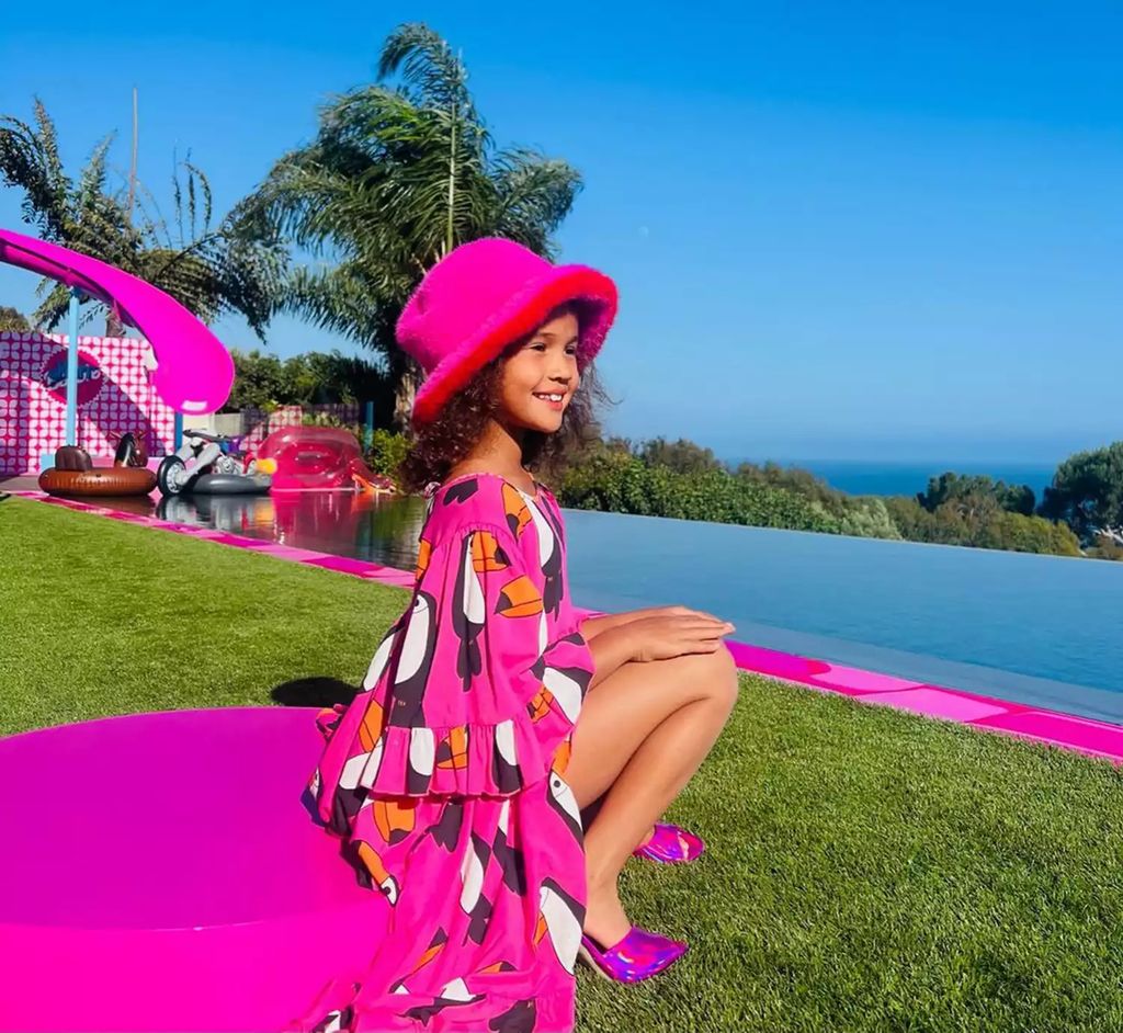 Chrissy's daughter hangs in the garden of the Barbie Malibu Dreamhouse