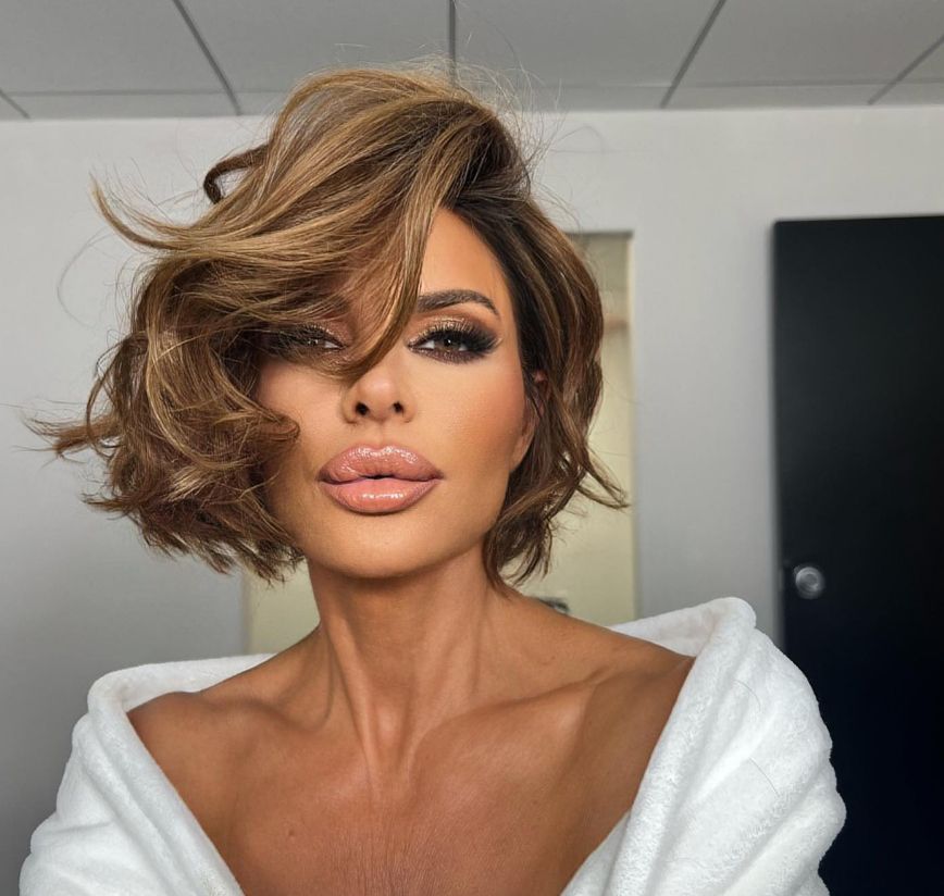 Lisa Rinna in white dressing gown with nude-colored lips