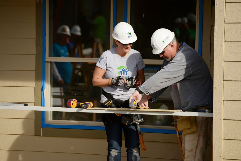 Trisha Yearwood and Garth Brooks work on building a home during Habitat for Humanity's Carter Work Project event in the Globeville Neighborhood in Denver, October 09, 2013