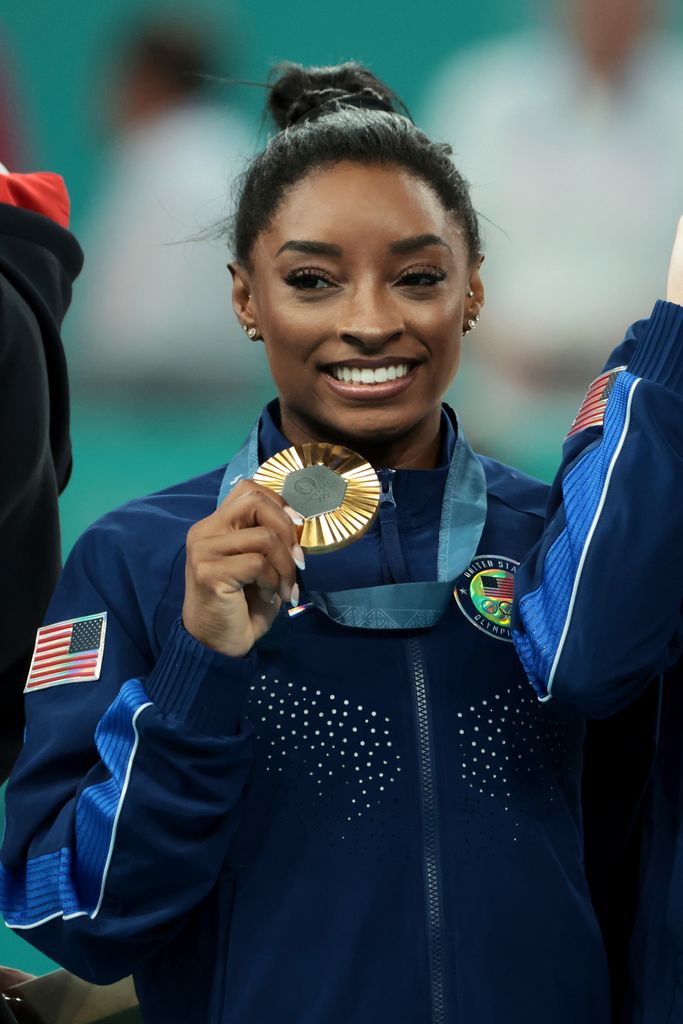 Gold medalist Simone Biles of Team USA celebrates on the podium during the medal ceremony for the Artistic Gymnastics Women's Team Final 