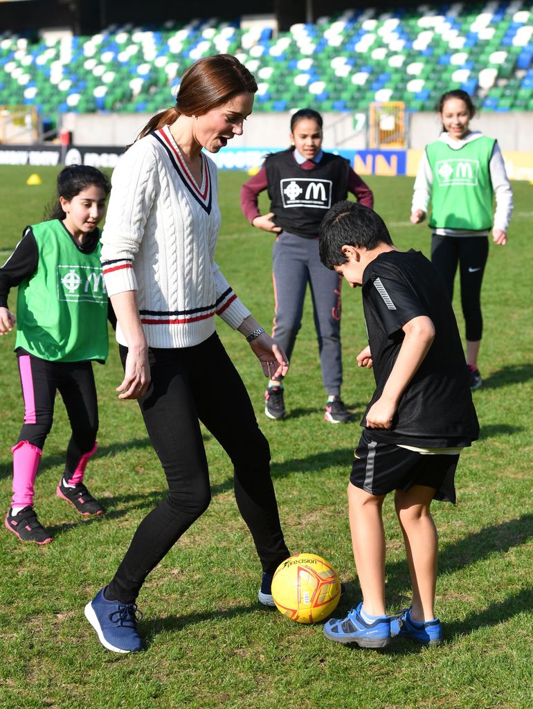 Princess Kate  takes part in a football training session with children during a visit the National Stadium in Belfast, home of the Irish Football Association on February 27, 2019