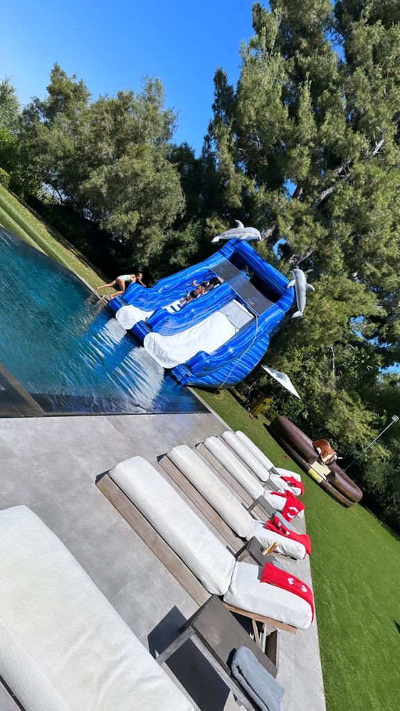 Scott put an inflatable slide up in the backyard for Penelope and her friends