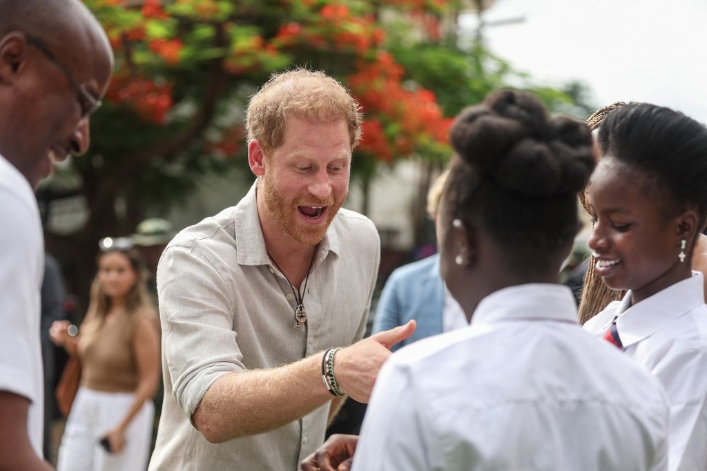 Duke of Sussex greet students as he arrives at the Lightway Academy in Abuja on May 10, 2024
