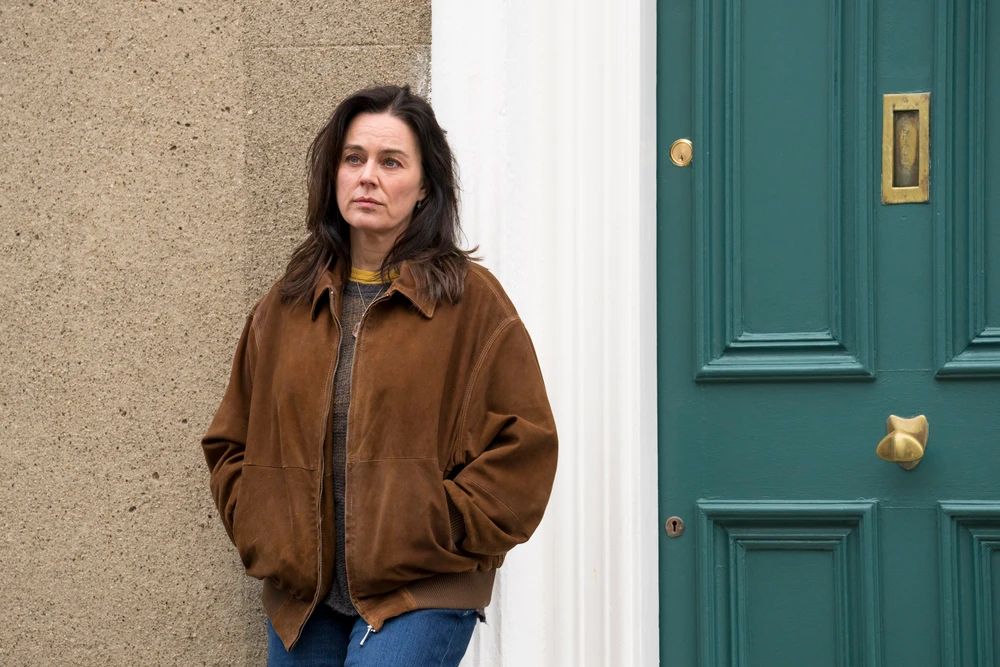 woman standing outside house