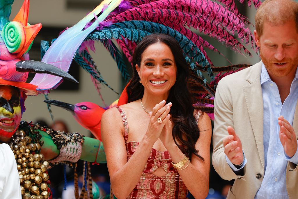 Meghan markle smiling and clapping with harry