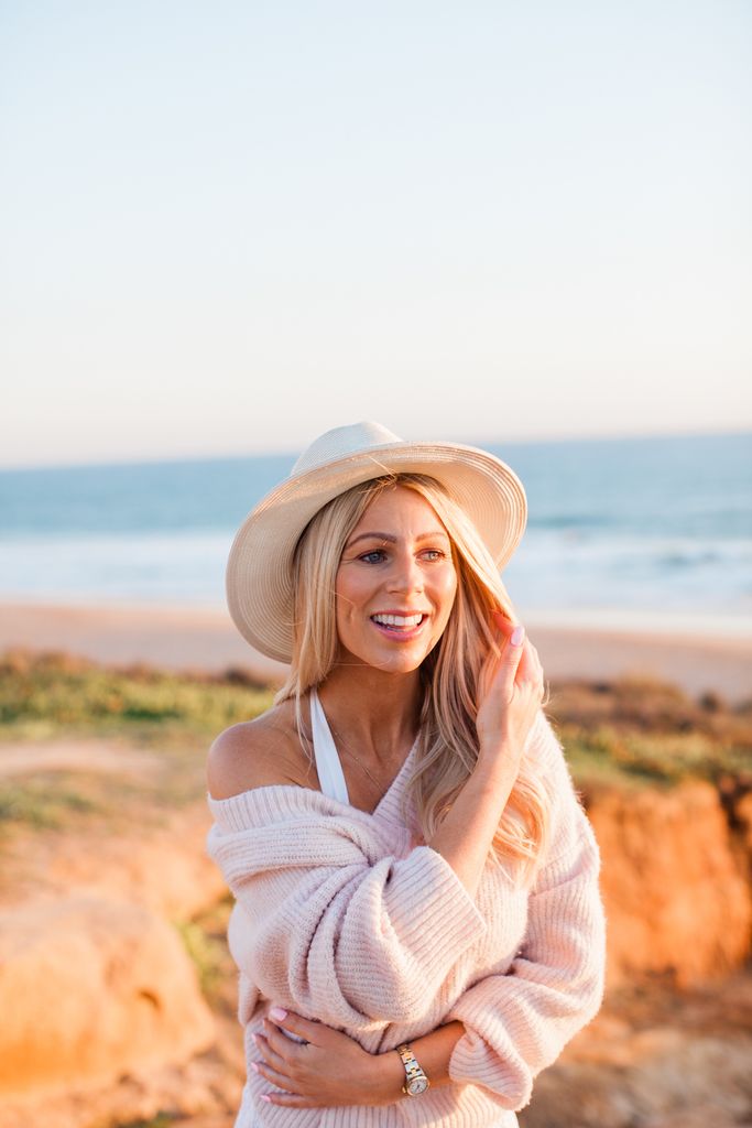Blonde woman in a hat at the beach